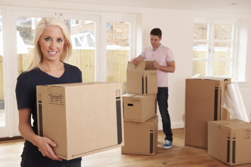 Moving van and packed boxes during a house removal in Brompton